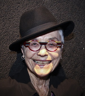 Barbara Hammer smiling and wearing a fedora